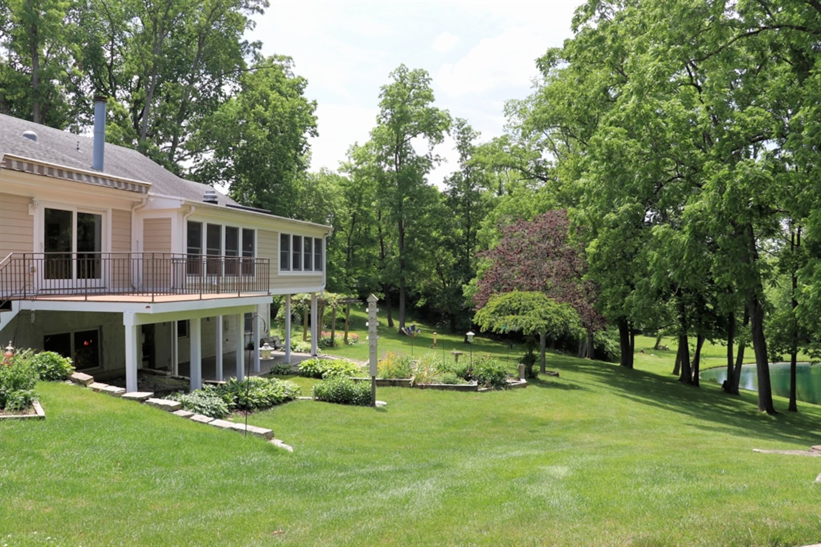 Stone walls accent the backyard and give dimension to the hills that lead to a pond.