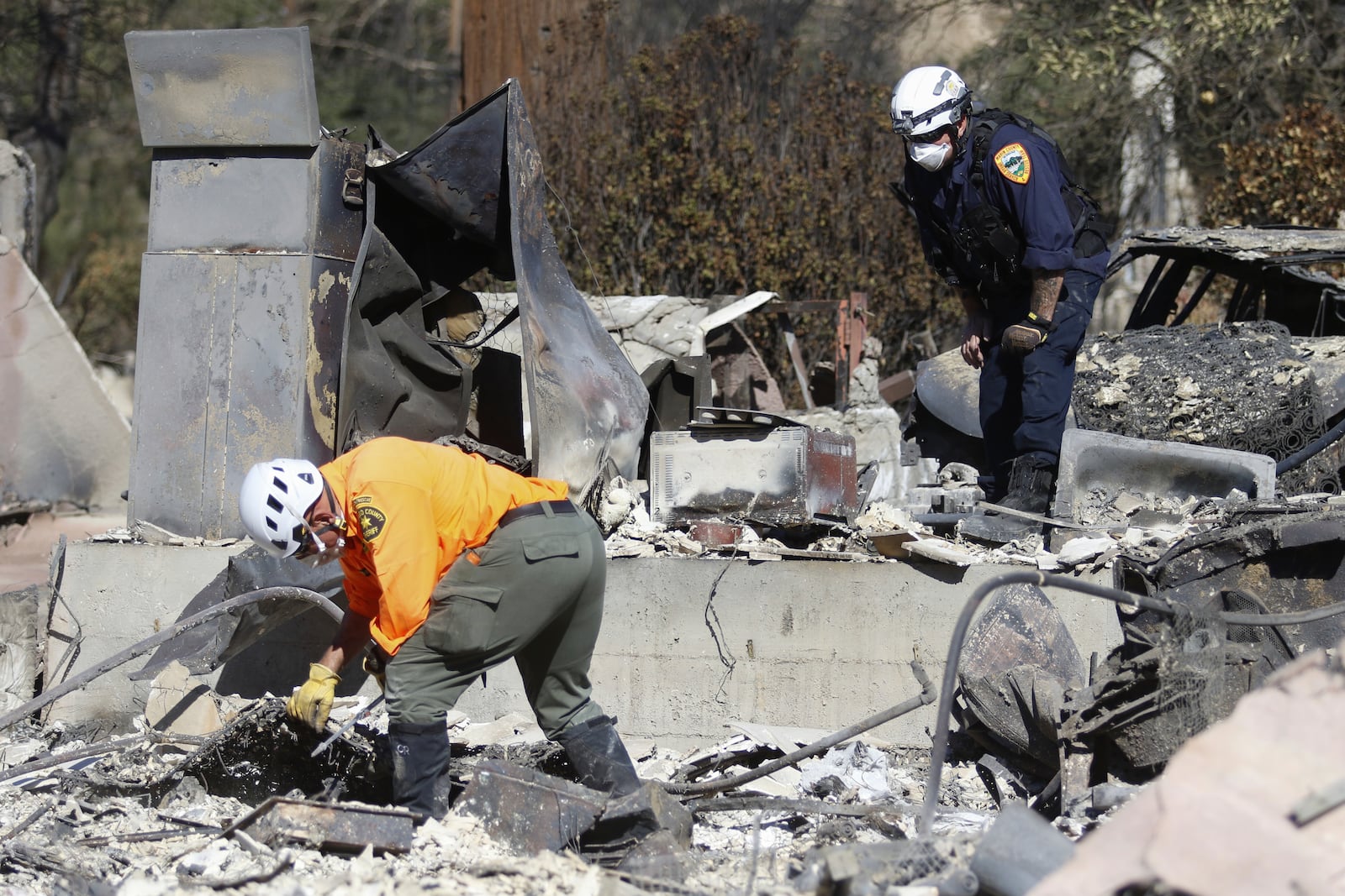 Search and rescue workers dig through the rubble left behind by the Eaton Fire, in Altadena, Calif., Tuesday, Jan. 14, 2025. (AP Photo/Ty O'Neil)