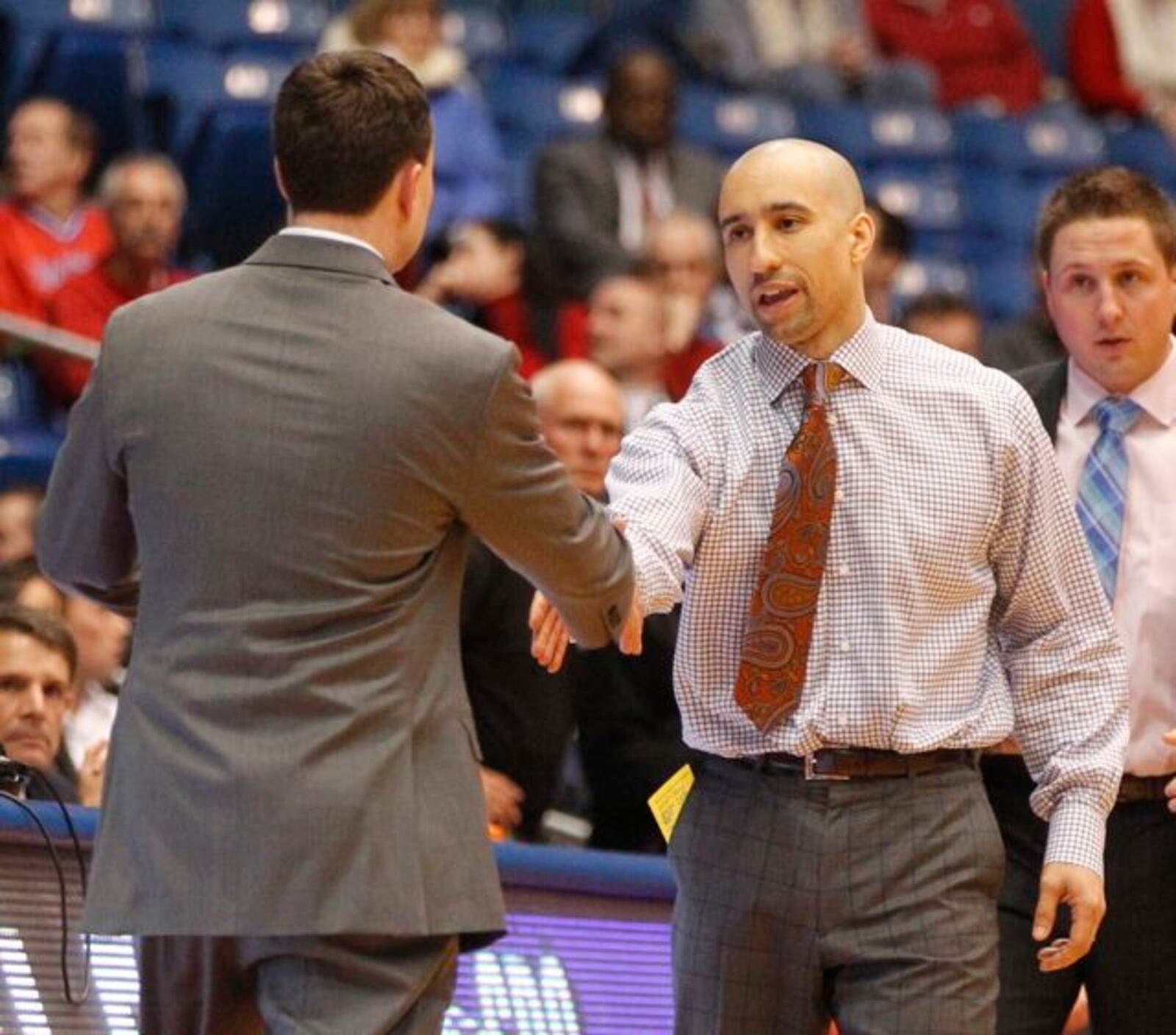 Dayton coach Archie Miller, left, shakes hands with Virginia Commonwealth coach Shaka Smart on Wednesday, Jan. 22, 2014, at UD Arena.