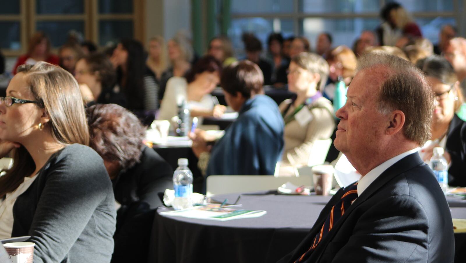 Former U.S. Congressman Tony Hall listens to speakers at the Montgomery County Food Summit held earlier this month. Speakers discussed issues of food access, sustainability and the relationship between hunger and economics. CORNELIUS FROLIK / STAFF