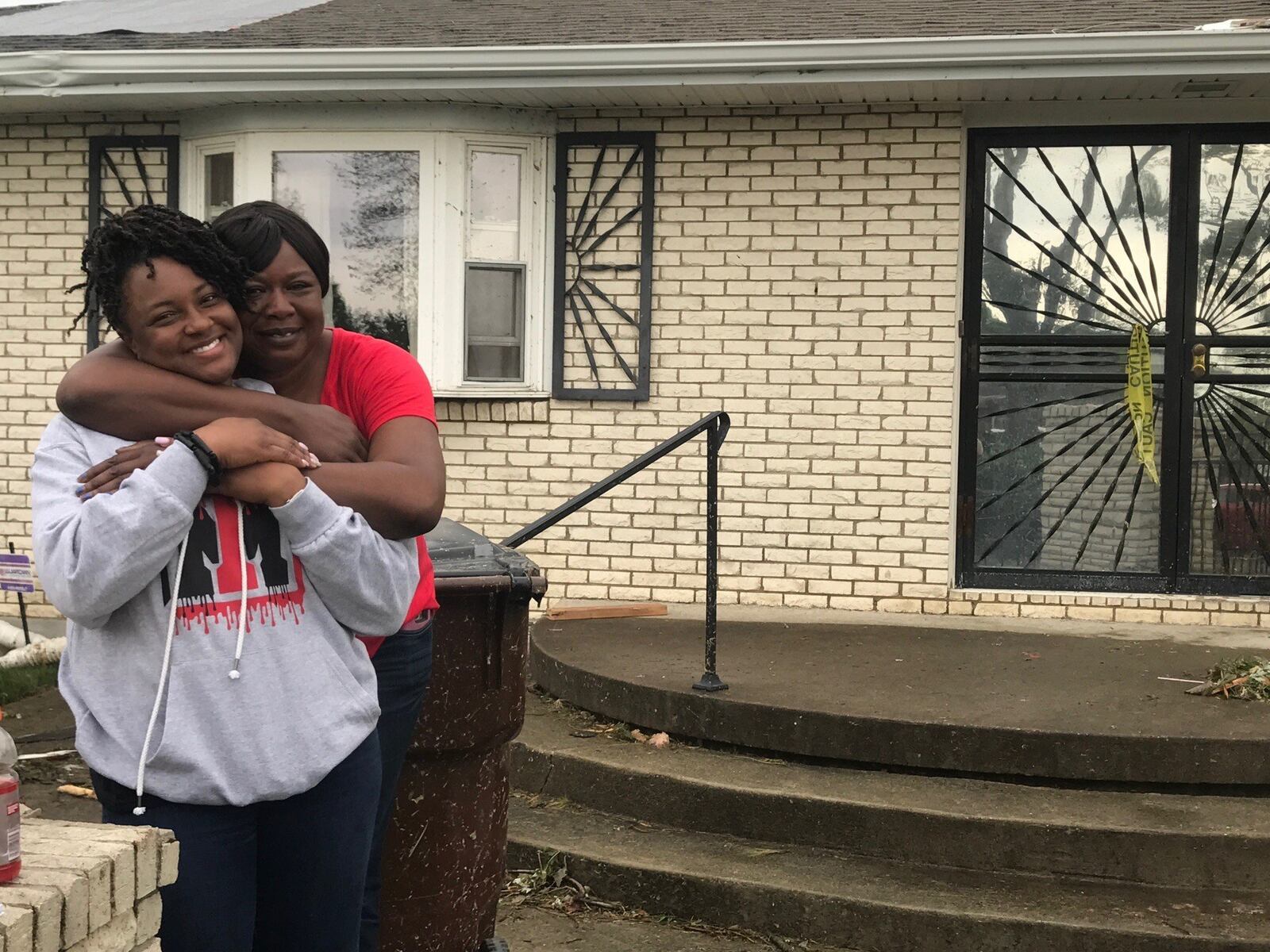 Tosha Johnson gets hug of support from Yamenneh Archimalo. Photo by Tom Archdeacon