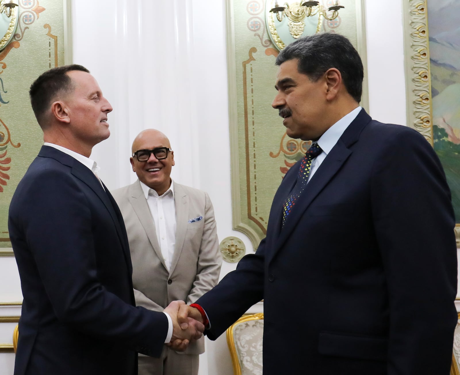 This photo released by Venezuela's presidential press office shows Venezuelan President Nicolas Maduro, right, shaking hands with Richard Grenell, President Donald Trump's special envoy, at Miraflores presidential palace in Caracas, Venezuela, Friday, Jan. 31, 2025. Behind is Jorge Rodriguez, president of the National Assembly. (Venezuela's presidential press office, via AP)