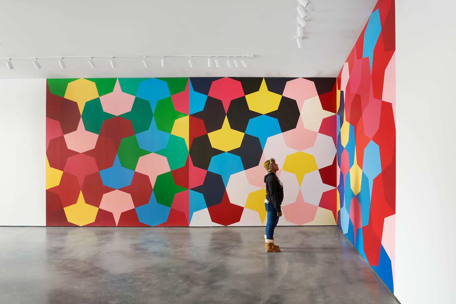 A visitor views Odili Donald Odita's mural at The Contemporary in Dayton. CONTRIBUTED