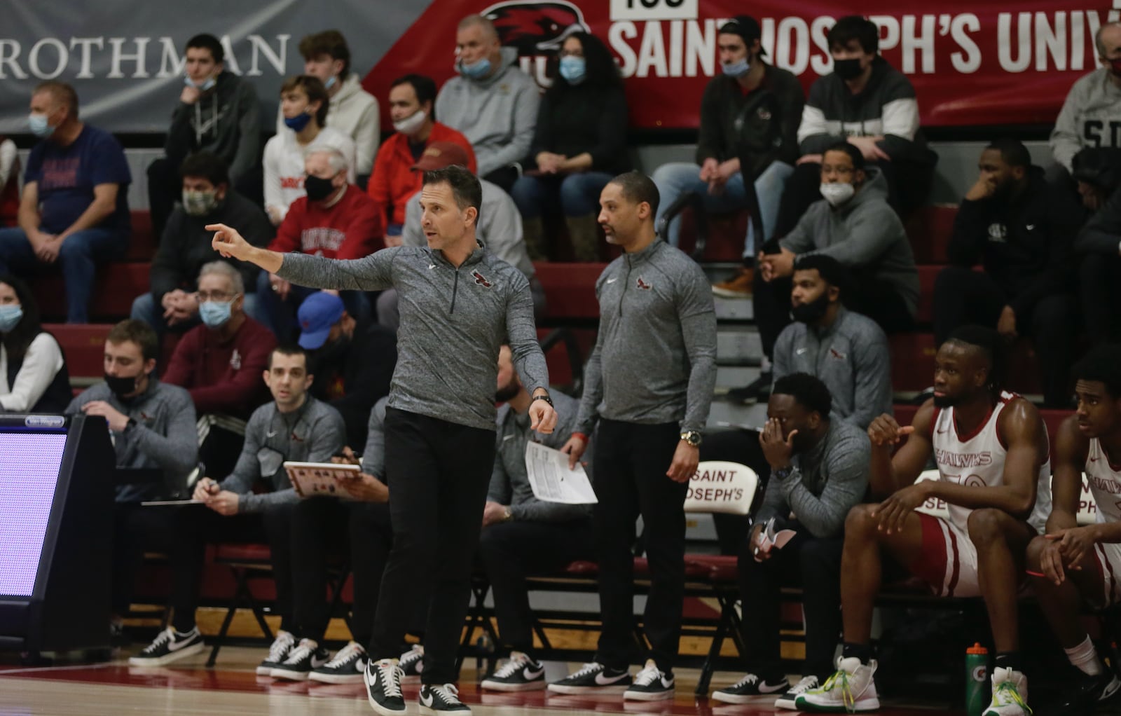 Saint Joseph’s Bill Lange, front left, coaches during a game against Dayton on Saturday, Feb 19, 2022, at Hagan Arena in Philadelphia, Pa. David Jablonski/Staff