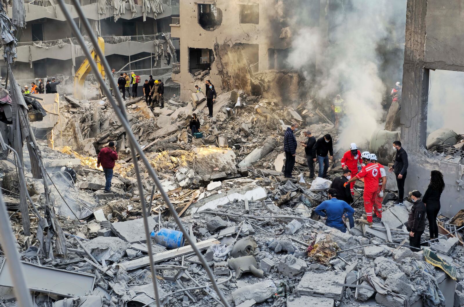 Rescue workers and people search for victims at the site of an Israeli airstrike that hit central Beirut, Lebanon, Saturday, Nov. 23, 2024. (AP Photo/Hassan Ammar)