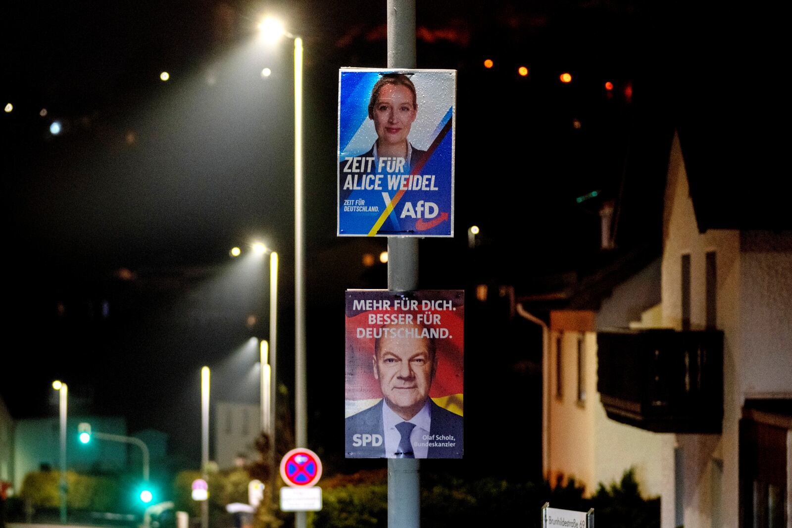 Election posters showing German Chancellor Olaf Scholz, bottom, and AfD top candidate Alice Weidel in Niederreifenberg near Frankfurt, Germany, Friday, Jan. 31, 2025. (AP Photo/Michael Probst)