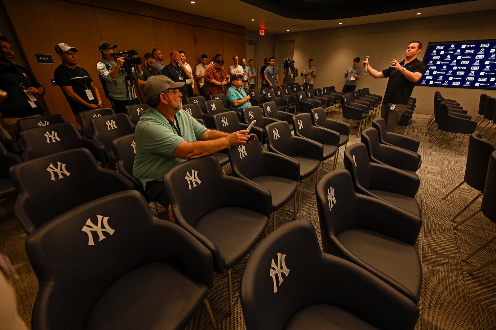 New York Yankees director of baseball operations Matthew Ferry, right, talks with the media in a team multi-purpose meeting room during a tour of the upgraded team spring training facilities, Thursday, Feb 13, 2025 at George M. Steinbrenner Field, in Tampa, Fla. (AP Photo/Steve Nesius)