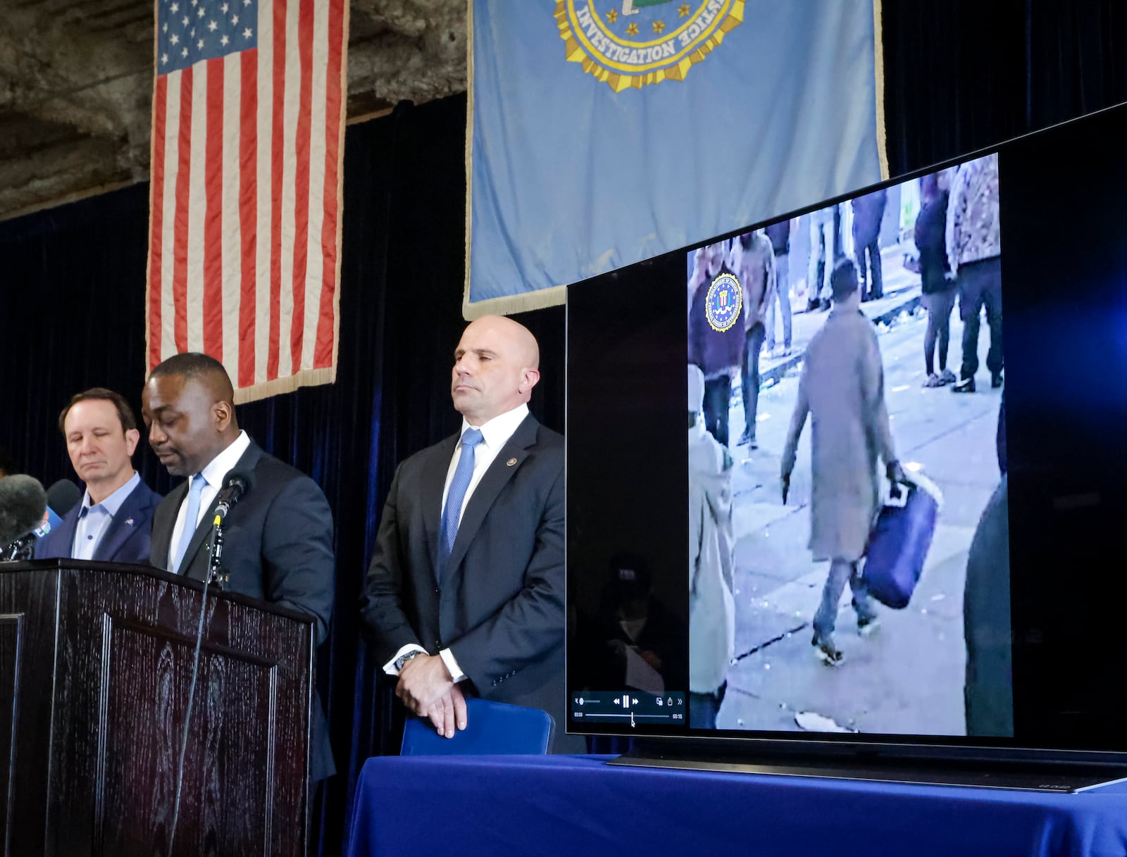 Lyonel Myrthil, special agent in charge of the New Orleans field office, second from left, shows footage of Shamsud-Din Jabbar, the man who carried out an attack on New Orleans' Bourbon Street on New Year's Day, during a news conference in a secure garage at the FBI Headquarters in New Orleans, Sunday, Jan. 5, 2025. (Scott Threlkeld/The Times-Picayune/The New Orleans Advocate via AP)