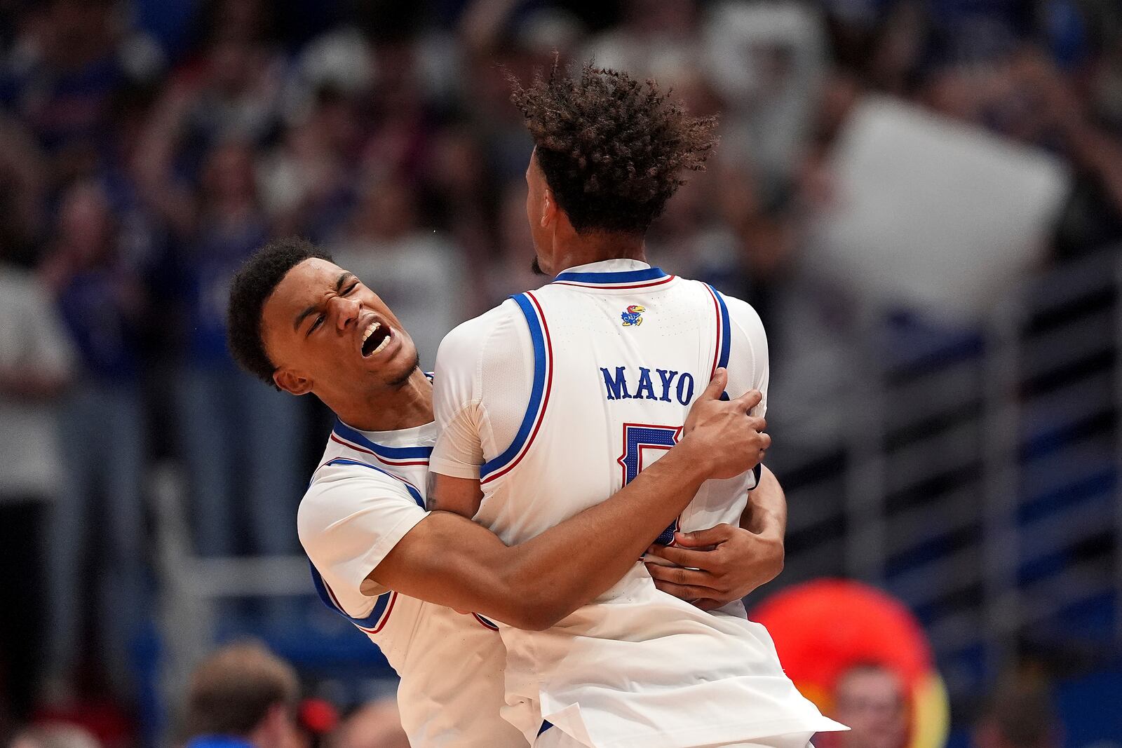 Kansas guards Rylan Griffen, left, and Zeke Mayo (5) celebrate after their NCAA college basketball game against North Carolina Friday, Nov. 8, 2024, in Lawrence, Kan. Kansas won 92-89. (AP Photo/Charlie Riedel)