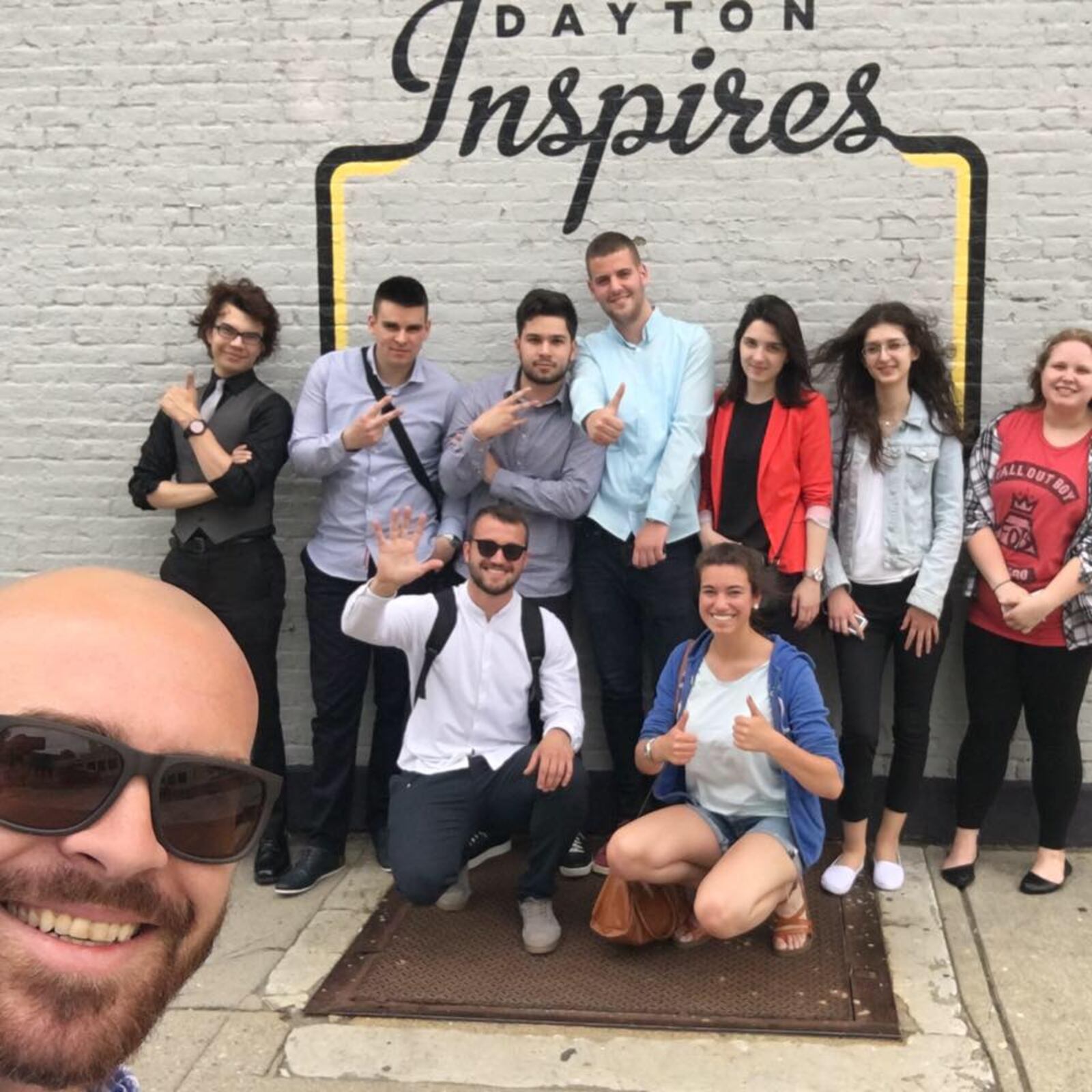 Arch Grieve (front), a mediation specialist at the Dayton Mediation Center, is the new chair of the Dayton Sister City Committee and is vice president of the Dayton Council on World Affairs. He is pictured with a group from Bosnia and Herzegovina in front of the Dayton Inspires mural in the Oregon District.