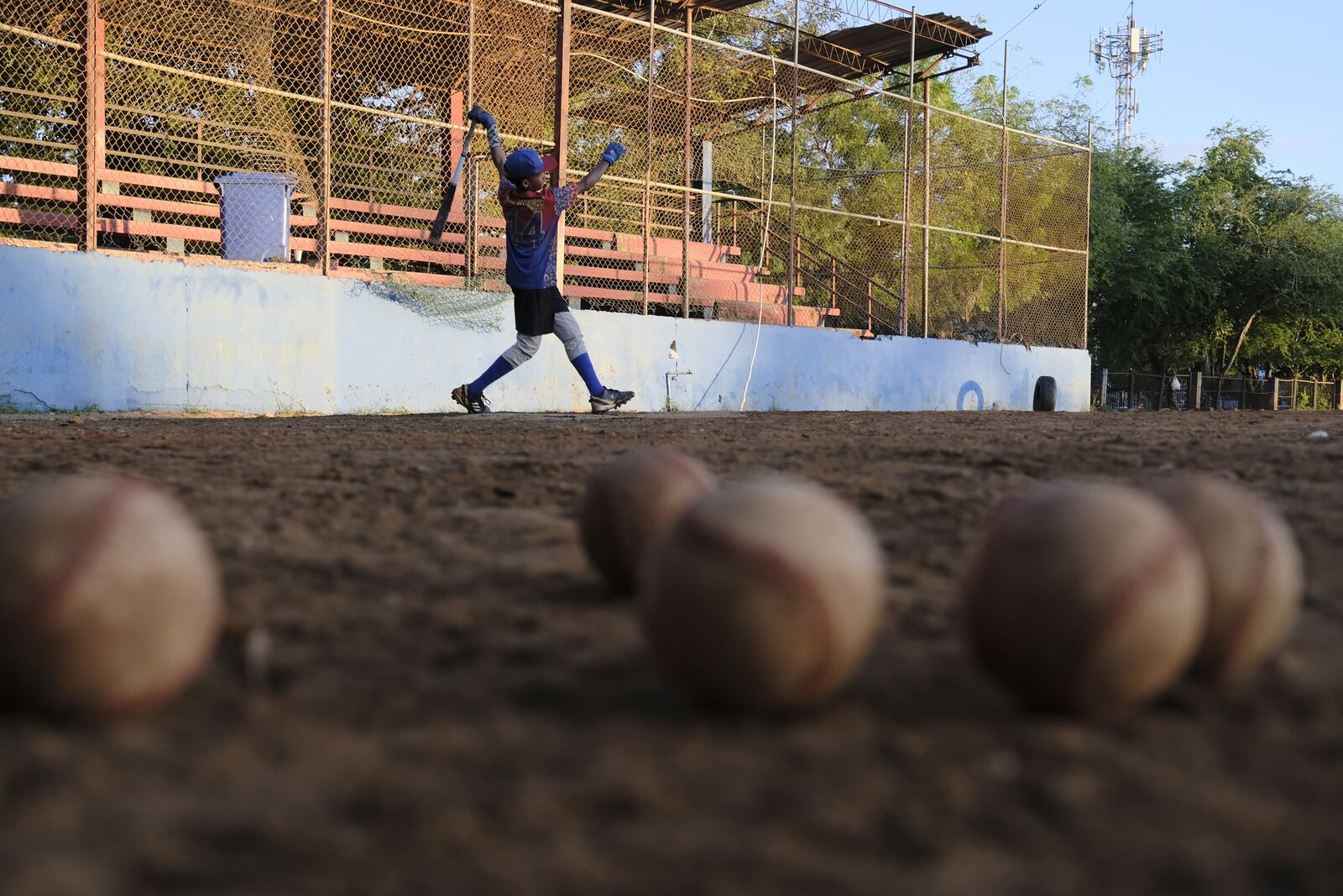 A young baseball player works to refine his swing during a daily training session at the Trinitarios ballpark in Santo Domingo, Dominican Republic, Wednesday, Feb. 5, 2025. (AP Photo/Ricardo Hernandez)