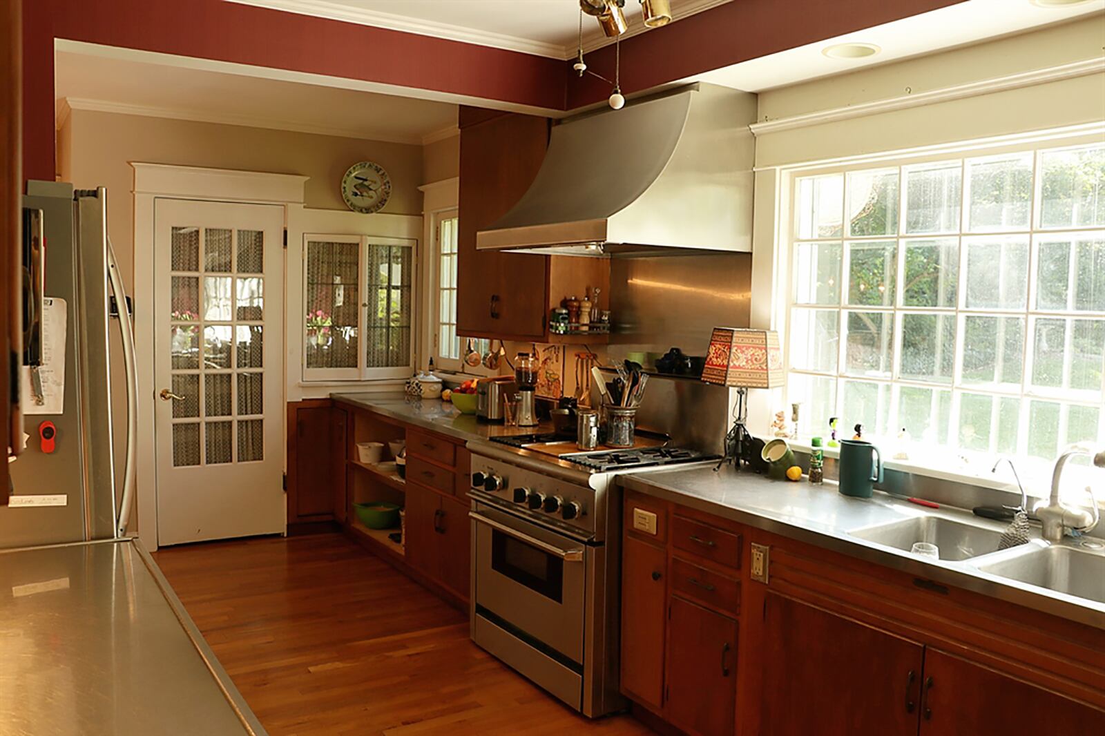 A picture window fills the galley kitchen with natural light. Stainless-steel countertops provide work space, and there is a spice cabinet and step-in pantry closet. CONTRIBUTED PHOTO BY KATHY TYLER