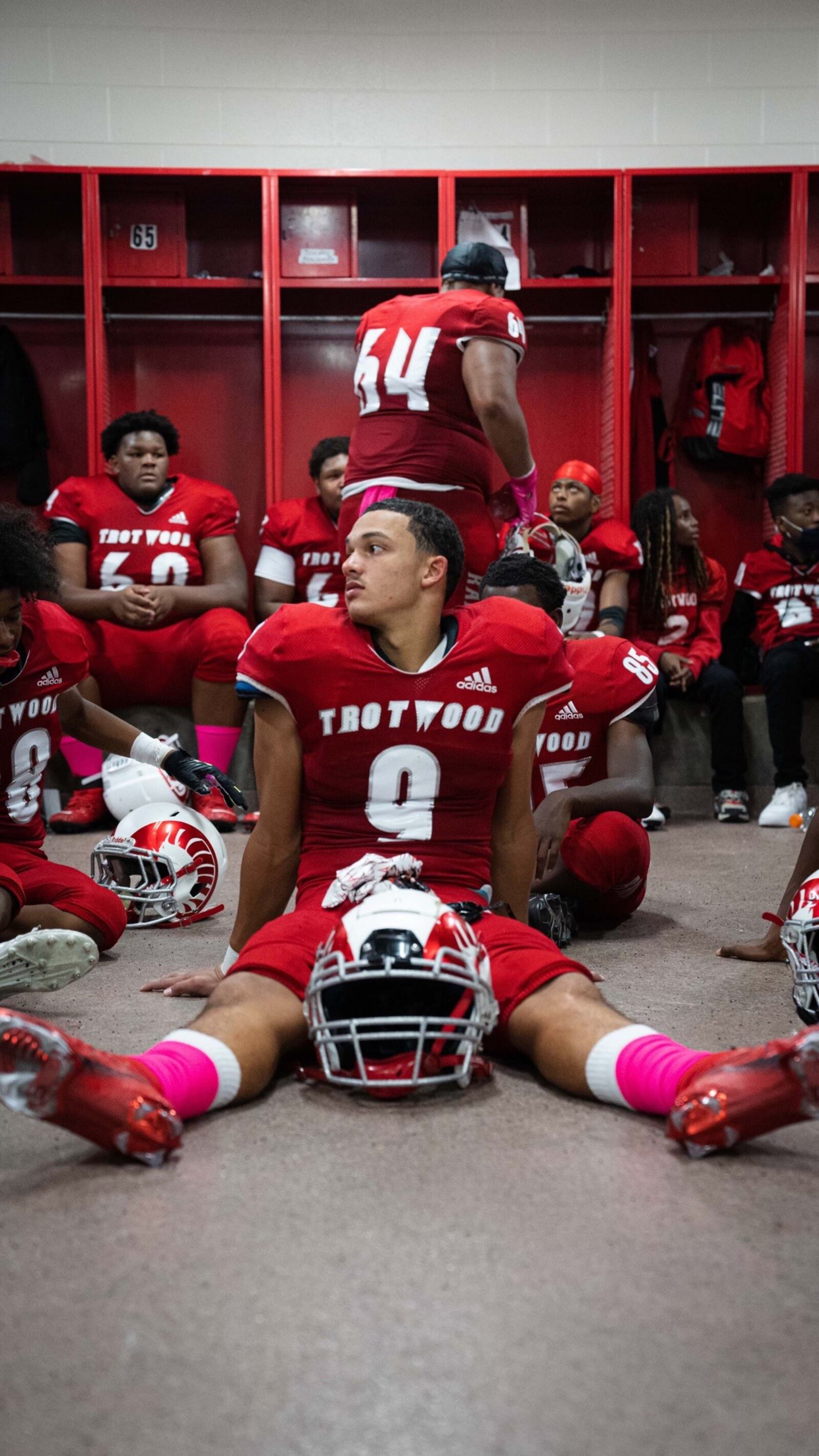 Issiah Evans  (No. 9) sits on the dressing room floor before a game last season. Then a sophomore linebacker, he was the leader of the defense and already was drawing scholarship interest from colleges.  (Contributed Photo)