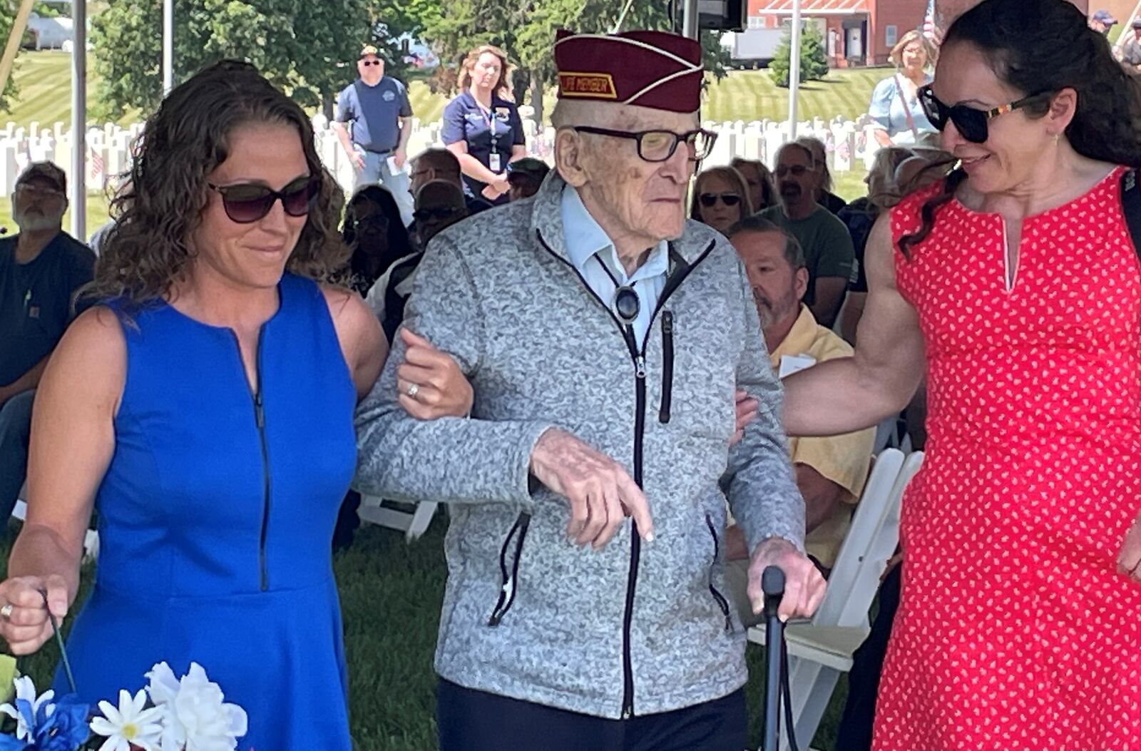 Former POW and World War II veteran Albert Brown is escorted as he was among those selected to lay wreaths Monday during of the Memorial Day ceremonies at the Dayton National Cemetery. NICK BLIZZARD/STAFF