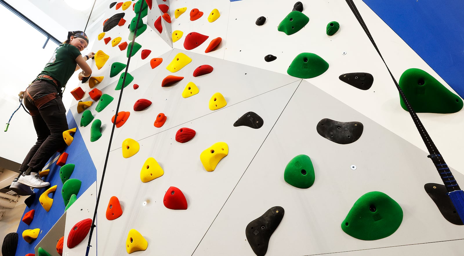 Staff member Aspen Goodwin safety-checks the rock climbing routes inside the new Dick's House of Sport at the Mall at Fairfield Commons. The grand opening was Friday, March 7, 2025. MARSHALL GORBY\STAFF