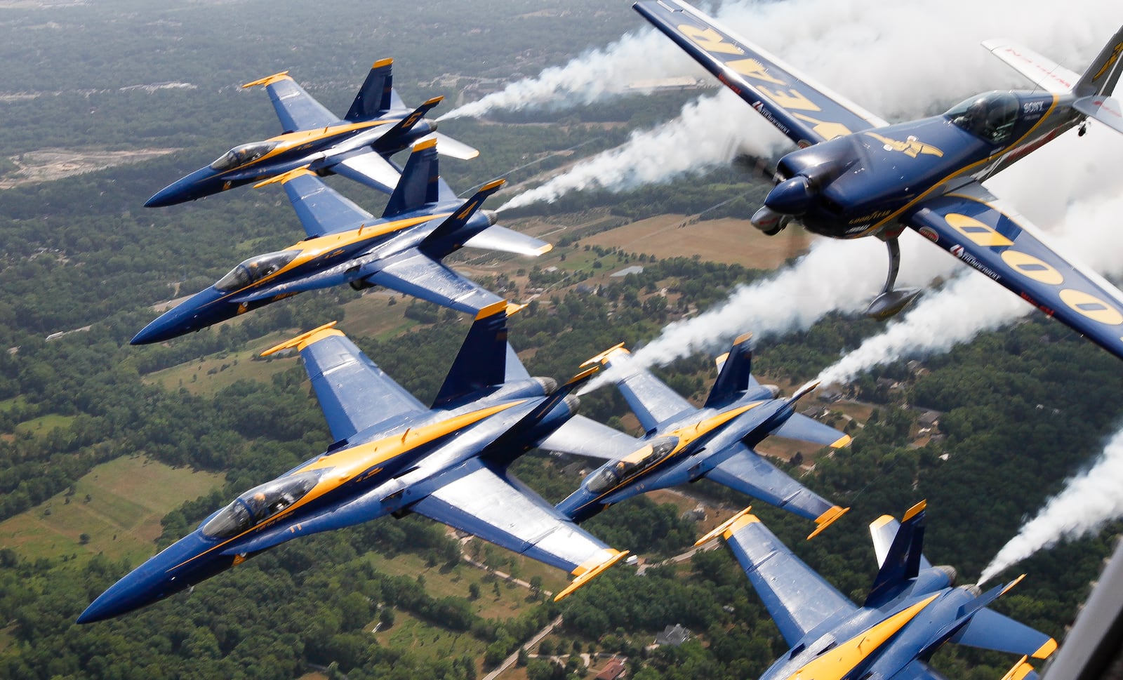 Aerobatic flyer Michael Goulian in his Extra 300SC flies in formation with the United States Navy Blue Angels over the Dayton Air Show in this file photo. 