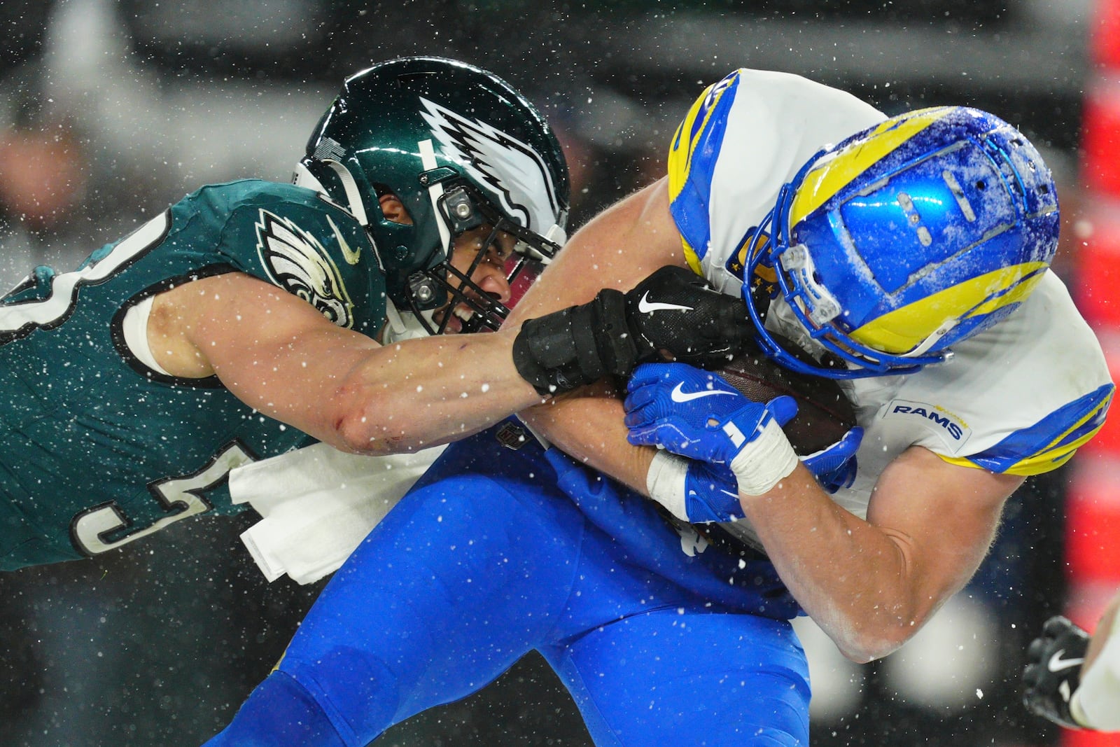 Los Angeles Rams running back Cody Schrader (32) is stopped by Philadelphia Eagles linebacker Zack Baun (53) during the second half of an NFL football NFC divisional playoff game Sunday, Jan. 19, 2025, in Philadelphia. (AP Photo/Derik Hamilton)