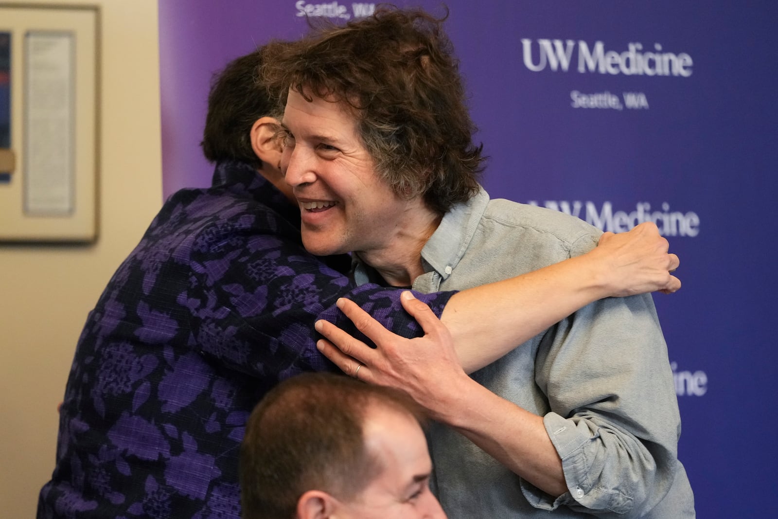 University of Washington president Ana Mari Cauce hugs American biochemist David Baker, 2024 Nobel Prize winner in Chemistry, during news conference at the university on Wednesday, Oct. 9, 2024, in Seattle. (AP Photo/Lindsey Wasson)