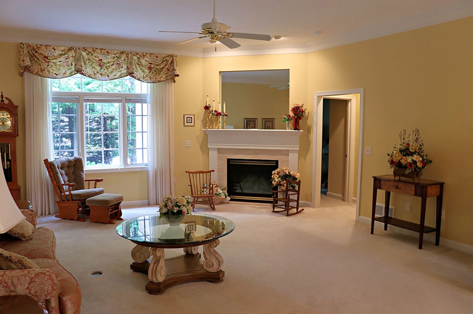 Tucked into one corner of the great room is a gas fireplace with fluted wood mantel, and there is an artwork nook above. Windows provide a view of the semi-private back yard with mature trees and a meditation garden. CONTRIBUTED PHOTO BY KATHY TYLER