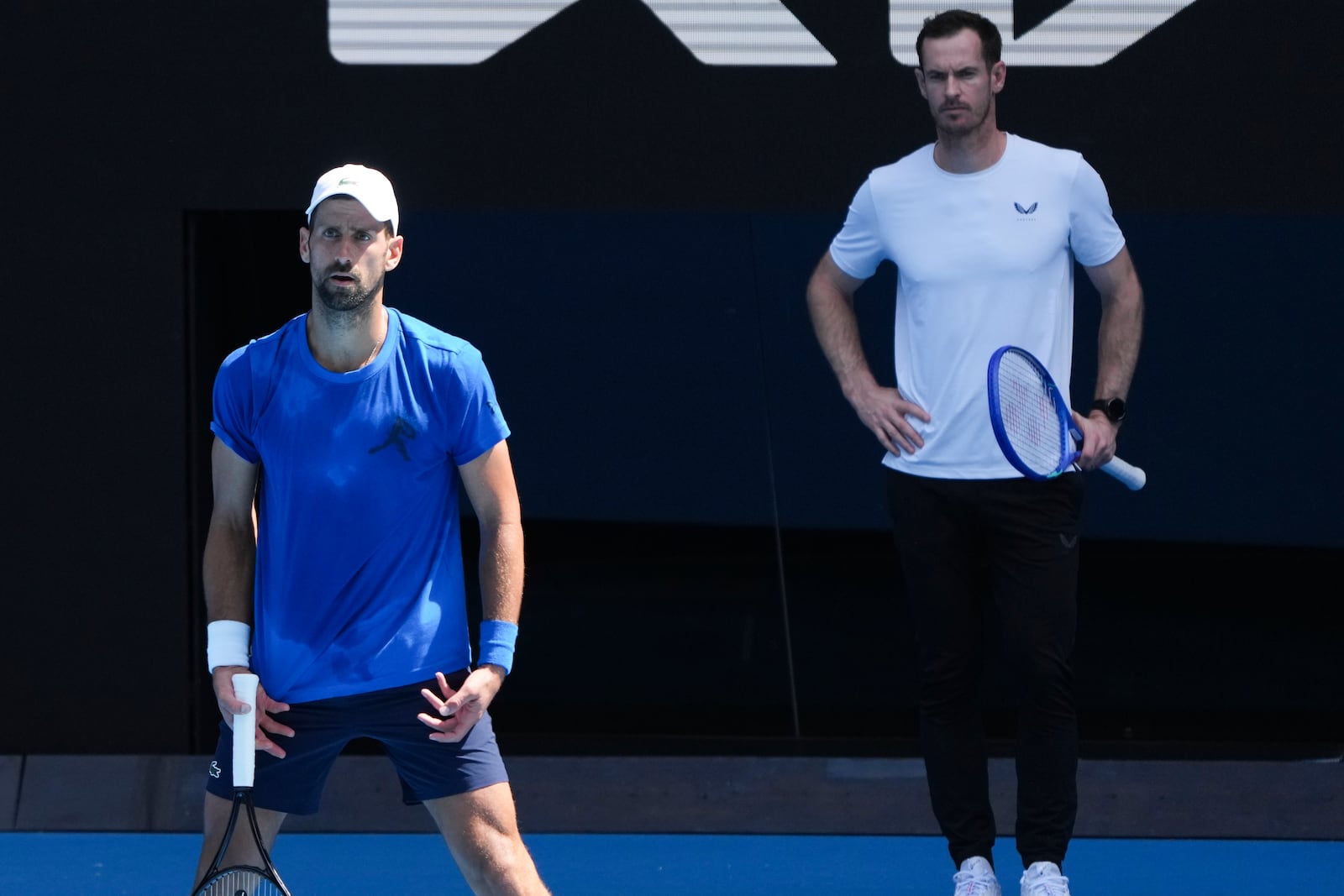 Serbia's Novak Djokovic is watches his coach Andy Murray, right, during a practice session ahead of the Australian Open tennis championship in Melbourne, Australia, Thursday, Jan. 9, 2025. (AP Photo/Mark Baker)