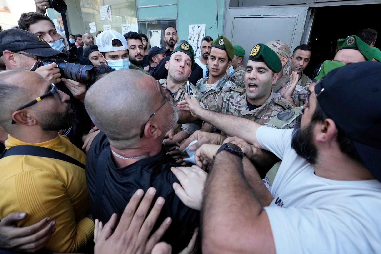 File - People displaced by Israel's war on Hezbollah scuffle with members of the Lebanese security, after dozens of policemen arrived at the building to evict the displaced from the private property in Hamra street, Beirut, Lebanon, Monday, Oct. 21, 2024. (AP Photo/Hassan Ammar, File)