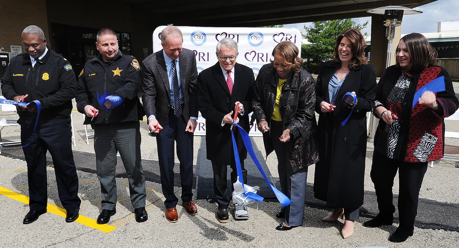 File - Ohio Governor Mike DeWine, center, with Montgomery County ADAMHS executive director Helen Jones-Kelley to the right, during the ribbon cutting ceremony at the Montgomery County Crisis Receiving Center on April 24, 2023. MARSHALL GORBY\STAFF FILE