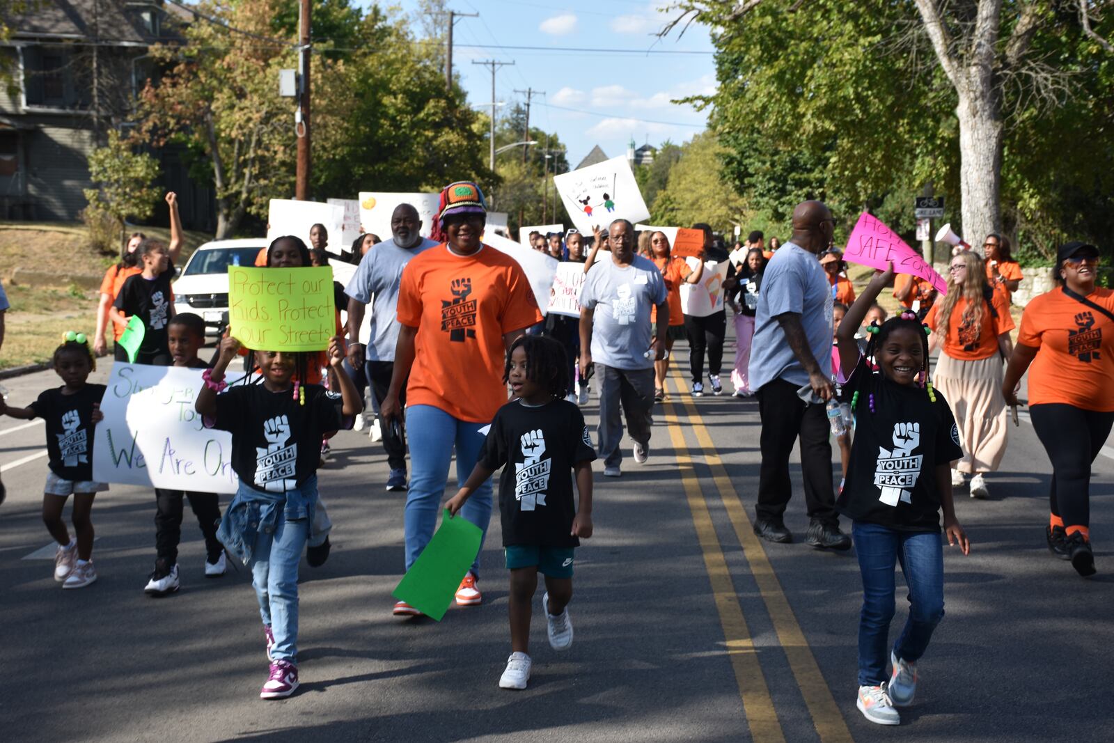 Kids, teens and adults marched down Broadway Street in northwest Dayton on Thursday as part of a peace march and rally in response to an increase in gun violence in the community. CORNELIUS FROLIK / STAFF