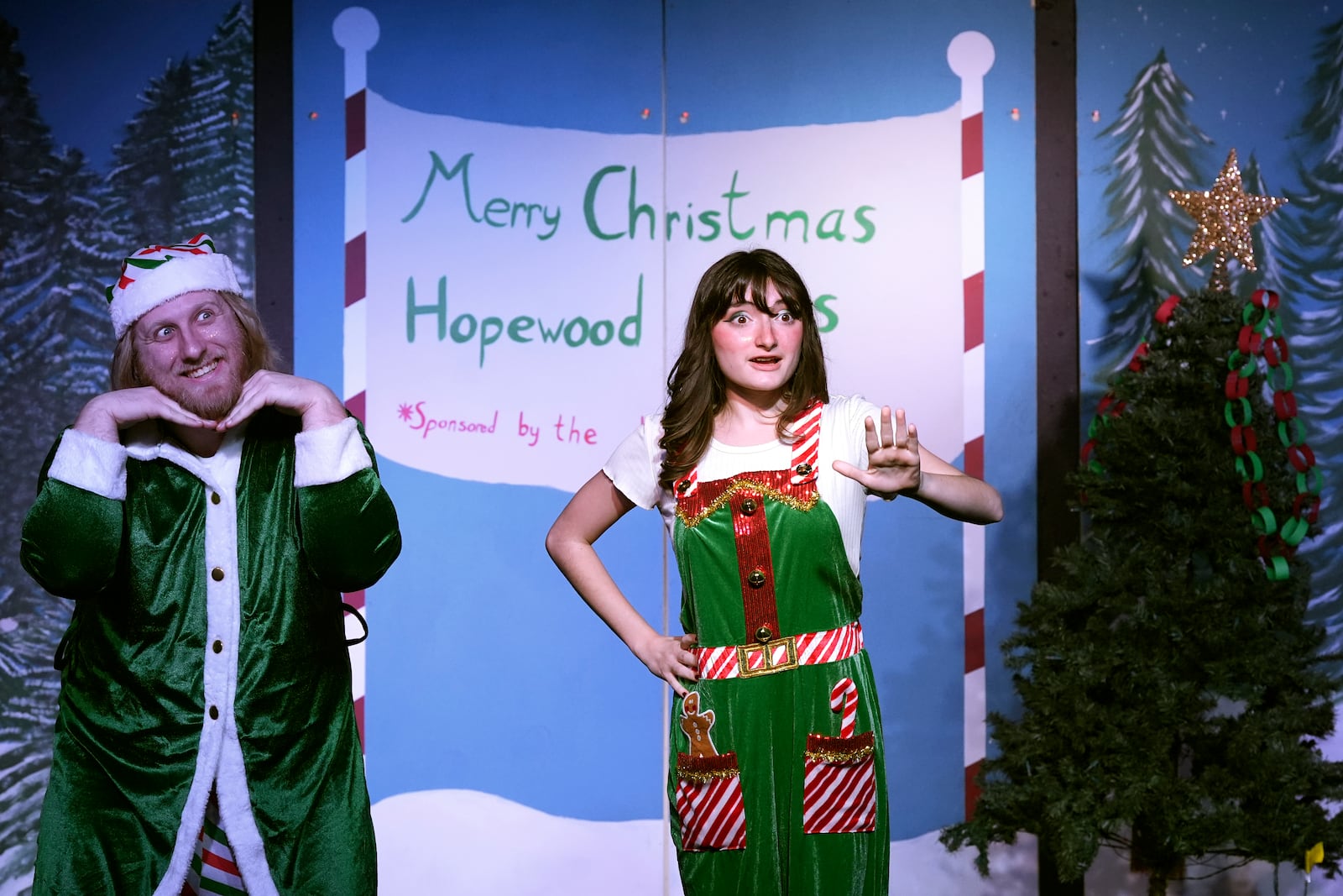 Narrators Kayla Patnod, right, and William Buckley introduce a scene during a dress rehearsal for the production of "The Holiday Channel Christmas Movie Wonderthon" at the Ghostlight Theatre in Sun City West, Ariz., on Dec. 9, 2024. (AP Photo/Ross D. Franklin)