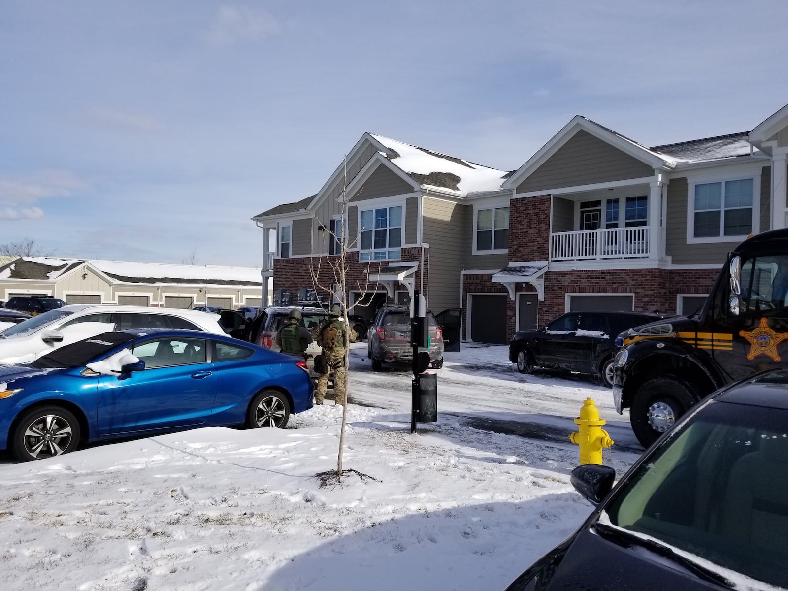 A view of the standoff at Springs at Liberty Township apartments as of 1:50 p.m. on Saturday, Jan. 13, 2018. WAYNE BAKER / STAFF