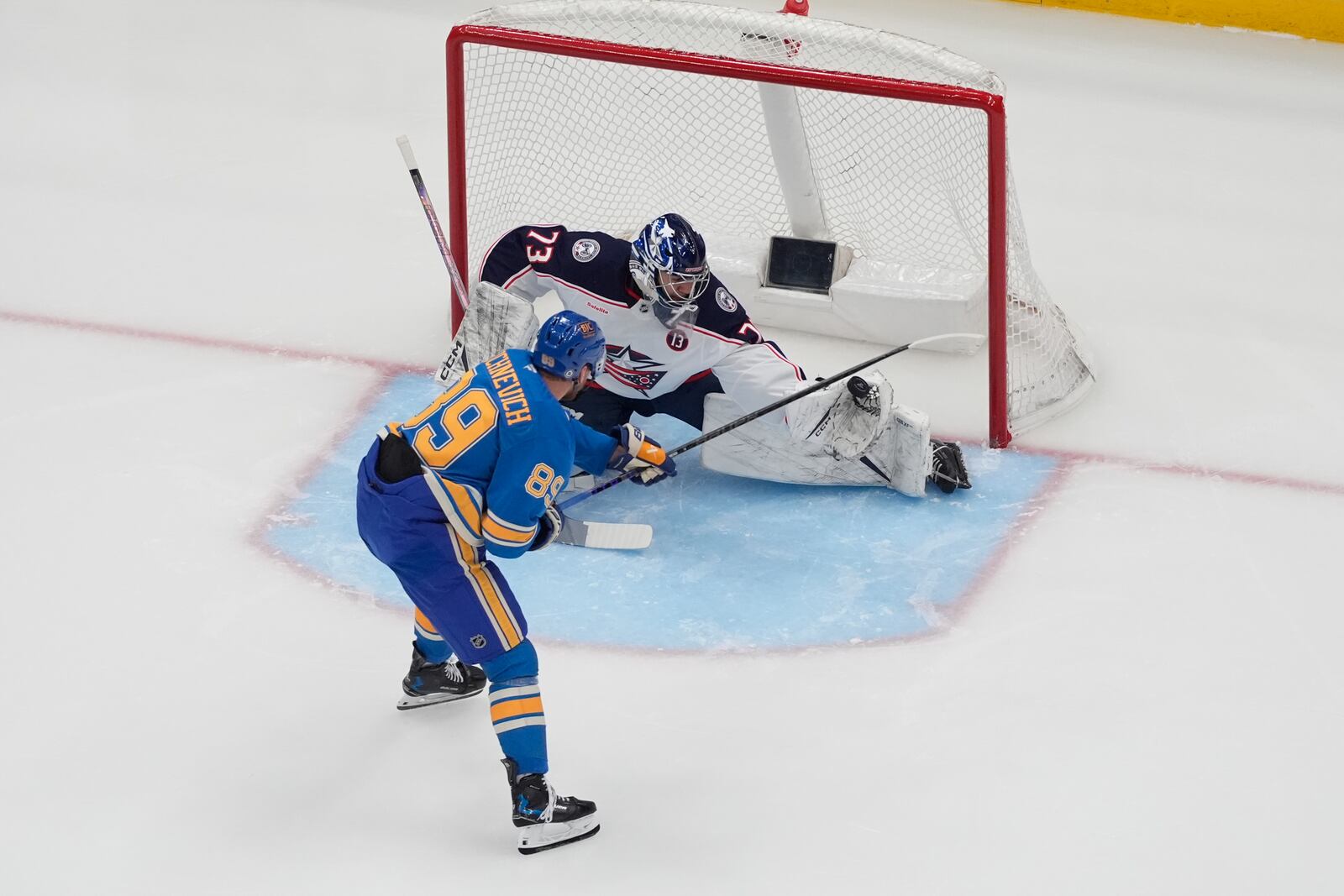 Columbus Blue Jackets goaltender Jet Greaves (73) stops a shot from St. Louis Blues' Pavel Buchnevich (89) during the third period of an NHL hockey game Saturday, Jan. 11, 2025, in St. Louis. (AP Photo/Jeff Roberson)