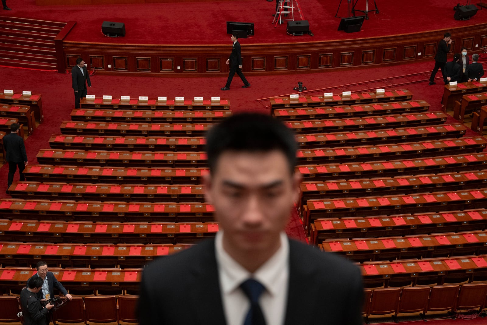 Documents are laid out for delegates before the closing ceremony of the National People's Congress held at the Great Hall of the People in Beijing, Tuesday, March 11, 2025. (AP Photo/Ng Han Guan)