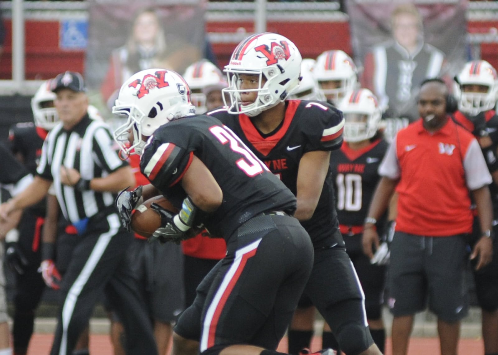 Wayne QB Rashad McKee (right) hands off to Devin Nelson. Wayne defeated visiting Northmont 49-20 in a Week 5 high school football game on Friday, Sept. 21, 2018. MARC PENDLETON / STAFF