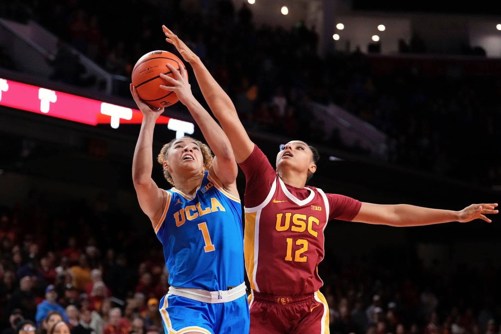 UCLA guard Kiki Rice, left, shoots as Southern California guard JuJu Watkins defends during the first half of an NCAA college basketball game Thursday, Feb. 13, 2025, in Los Angeles. (AP Photo/Mark J. Terrill)