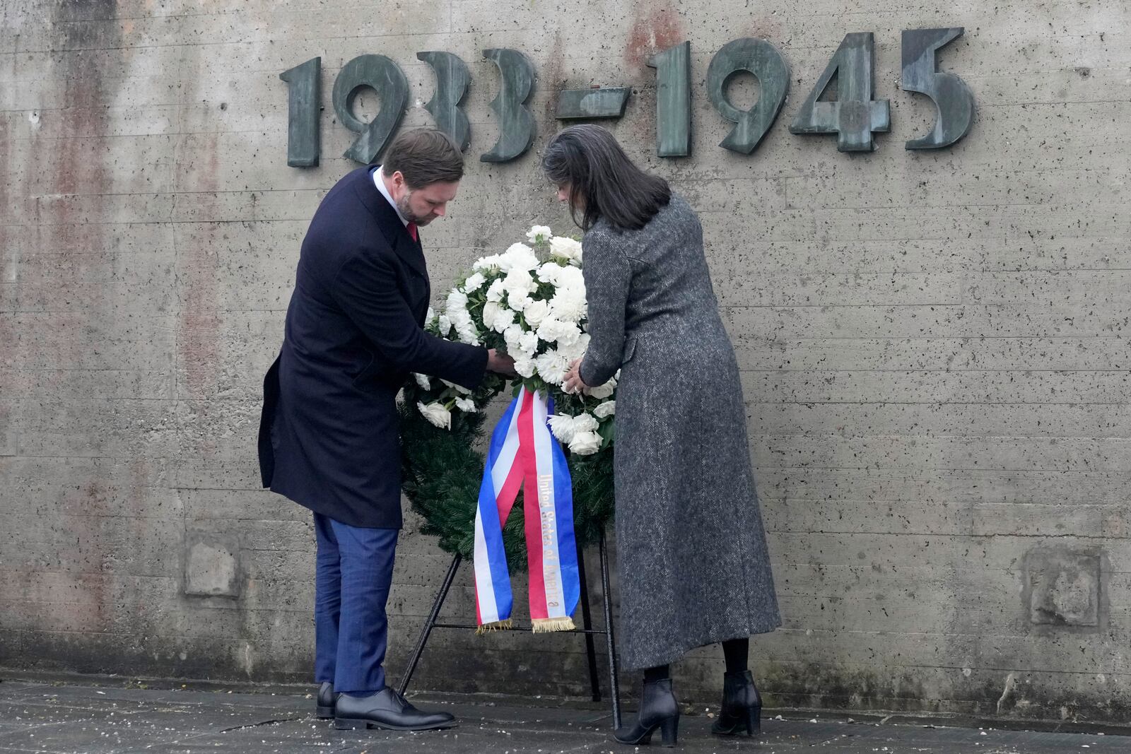 U.S. Vice President JD Vance and second lady Usha Vance lay a wreath at the Dachau Concentration Camp Memorial Site outside Munich, Germany, Thursday, Feb. 13, 2025. (AP Photo/Matthias Schrader)