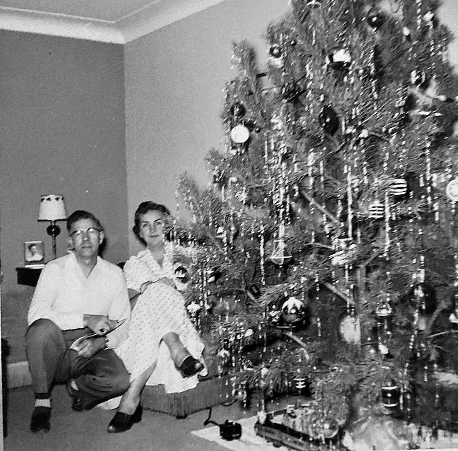 Erhardt's parents Mr. and Mrs. William Frederick Erhardt with the family Christmas tree in 1957. Erhardt remembers trains under the tree every year while growing up.