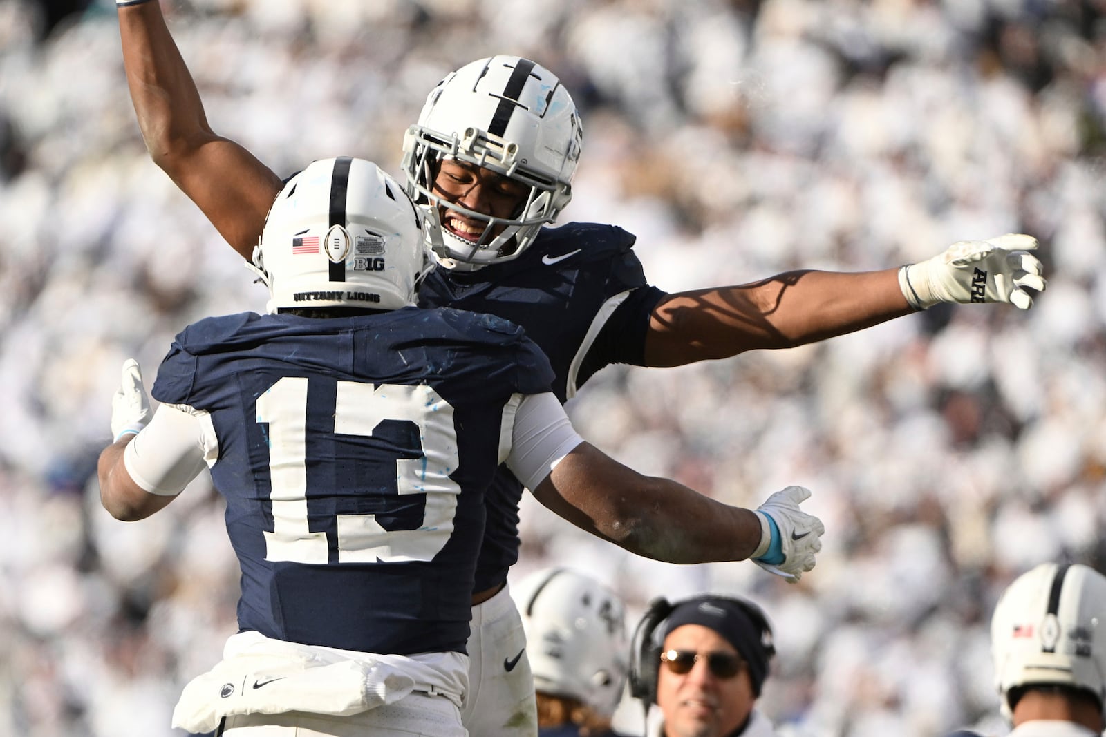 Penn State running back Kaytron Allen (13) celebrates after a touchdown with Nicholas Singleton, second from left, during the second half against SMU in the first round of the College Football Playoff, Saturday, Dec. 21, 2024, in State College, Pa. (AP Photo/Barry Reeger)