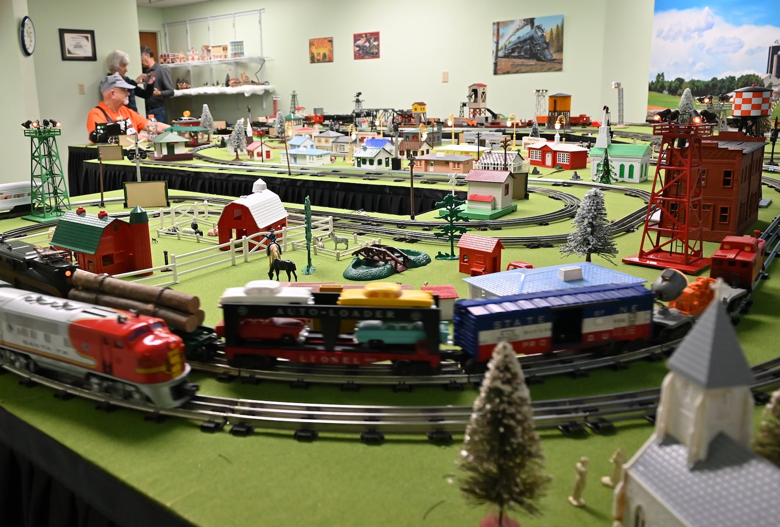 Erhardt (in orange shirt) sits in Bethany's Homestead "Train Room" greeting guests and talking trains on January 15 during the open house