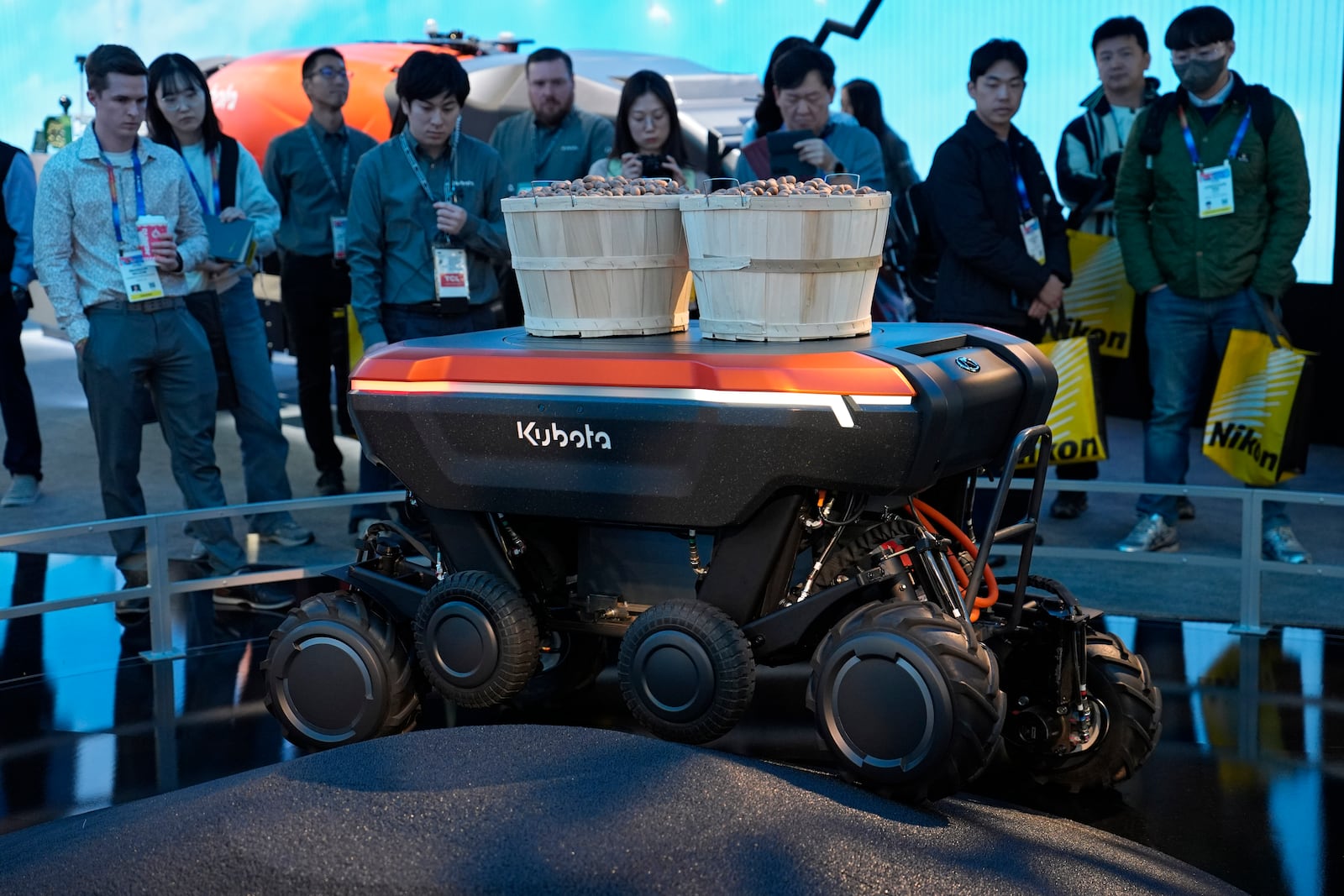 People view a demonstration of the KATR robot designed to work in agriculture and construction at the Kubota booth during the CES tech show Tuesday, Jan. 7, 2025, in Las Vegas. (AP Photo/John Locher)