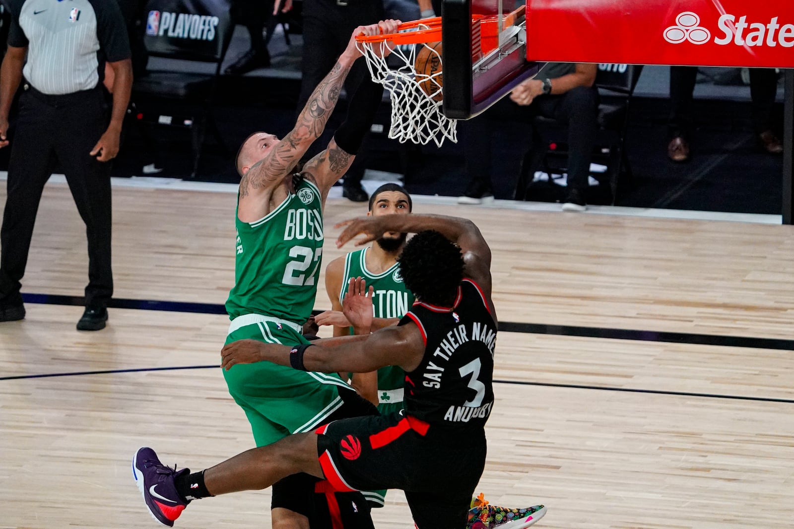 Boston Celtics center Daniel Theis (27) gets a dunk over Toronto Raptors forward OG Anunoby (3) during the second half of an NBA conference semifinal playoff basketball game Wednesday, Sept. 9, 2020, in Lake Buena Vista, Fla. (AP Photo/Mark J. Terrill)