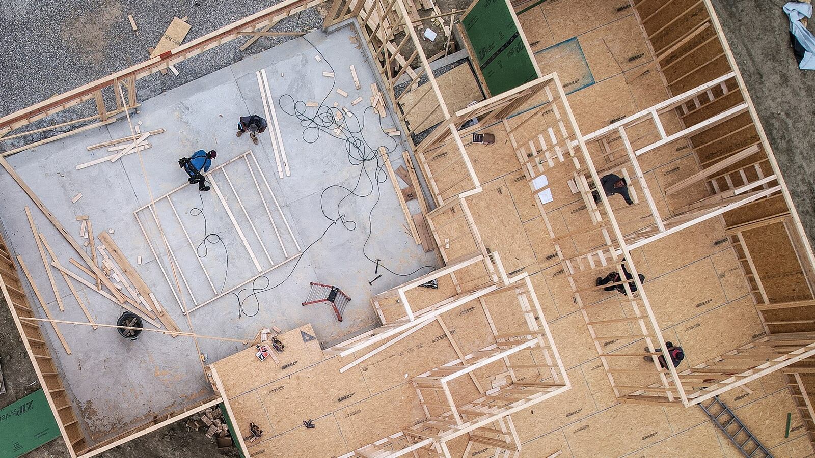 Home buildings work on the framing of a home on Chaumont Ave. near Centerville. Interest rate have been climbing consistently for the last few months and the cost of housing construction has gone up a full 19-plus percent. JIM NOELKER/STAFF