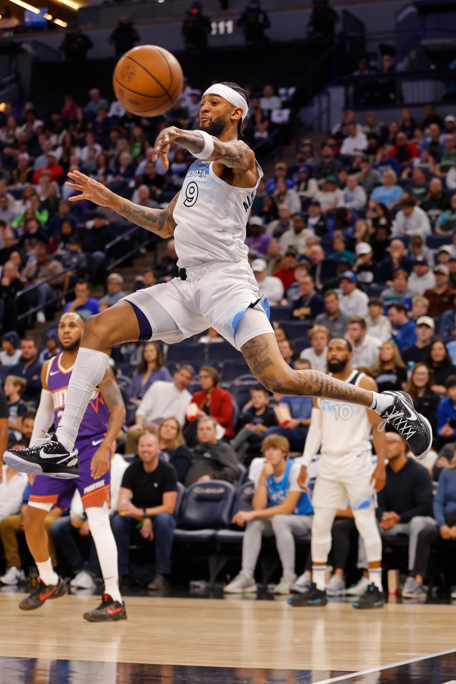 Minnesota Timberwolves forward Nickeil Alexander-Walker (9) passes the ball against the Phoenix Suns in the second quarter of an NBA basketball game Sunday, Nov. 17, 2024, in Minneapolis. (AP Photo/Bruce Kluckhohn)