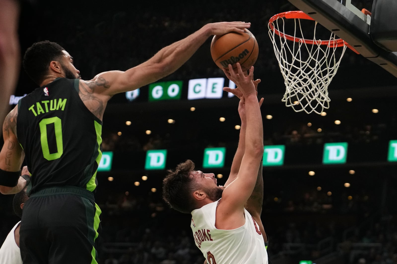 Boston Celtics forward Jayson Tatum (0) blocks a shot by Cleveland Cavaliers guard Ty Jerome, right, during the first half of an NBA basketball game, Friday, Feb. 28, 2025, in Boston. (AP Photo/Charles Krupa)