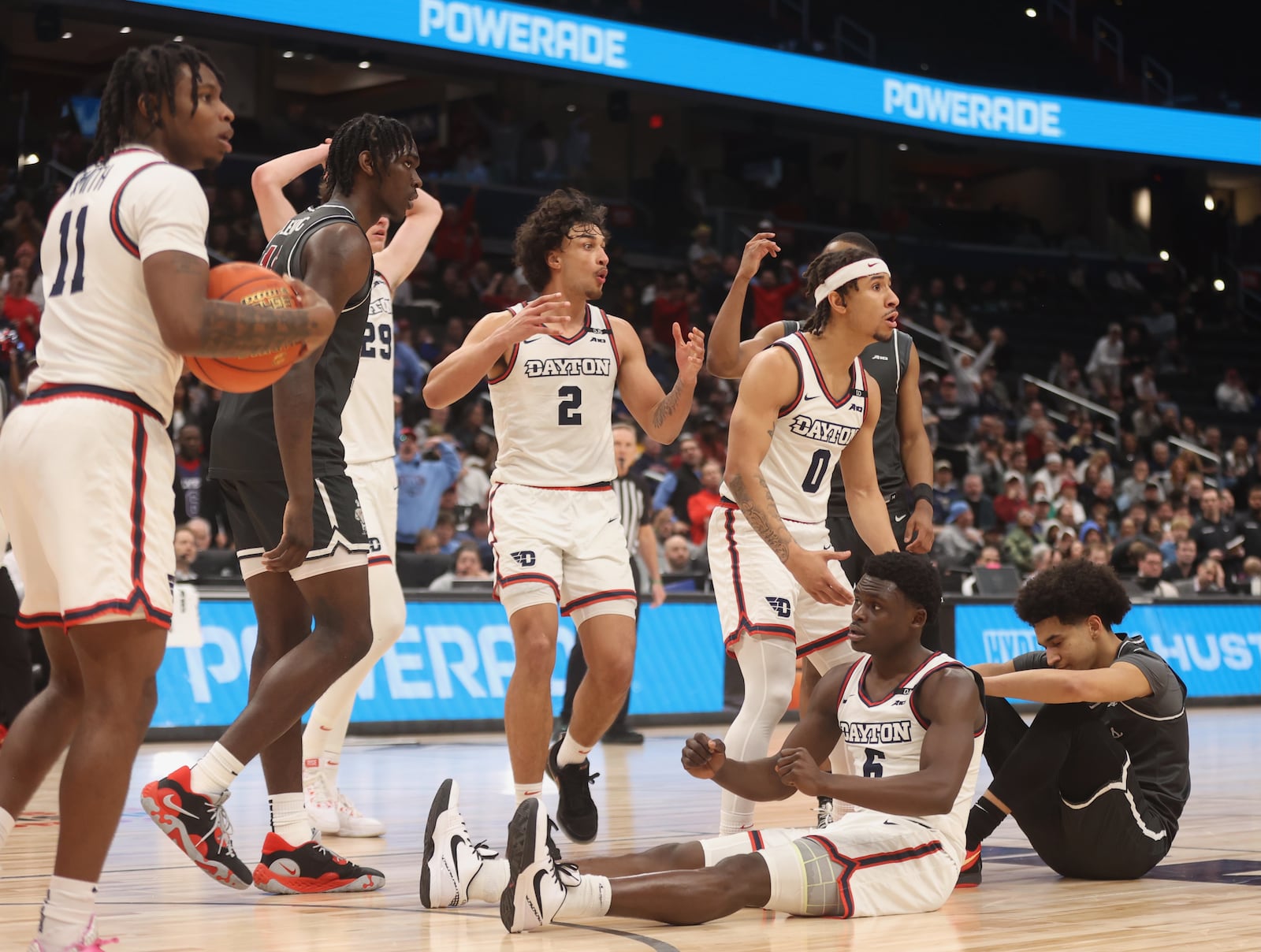 Dayton players react after Enoch Cheeks scored and drew a foul late in the second half against Saint Joseph’s on Friday, March 14, 2025, in the quarterfinals of the Atlantic 10 Conference tournament at Capital One Arena in Washington, D.C. Cheeks completed a 3-point play to give Dayton the lead. David Jablonski/Staff