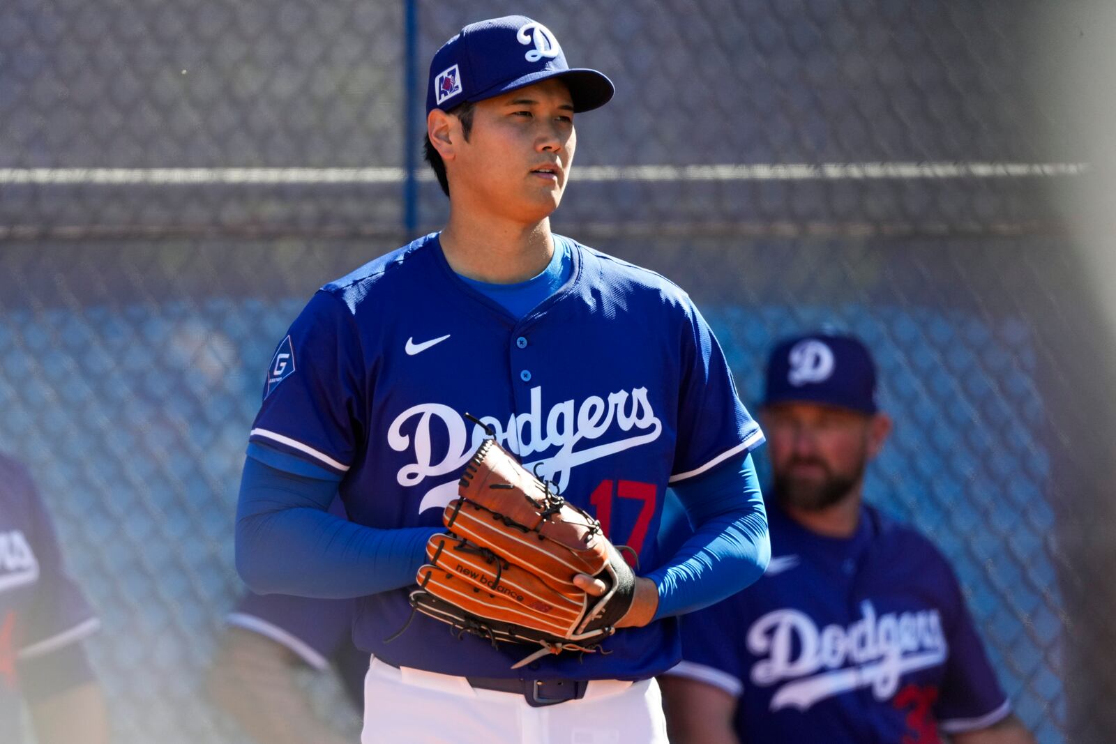 Los Angeles Dodgers two-way player Shohei Ohtani (17) works out during spring training baseball practice, Saturday, Feb. 15, 2025, in Phoenix. (AP Photo/Ashley Landis)