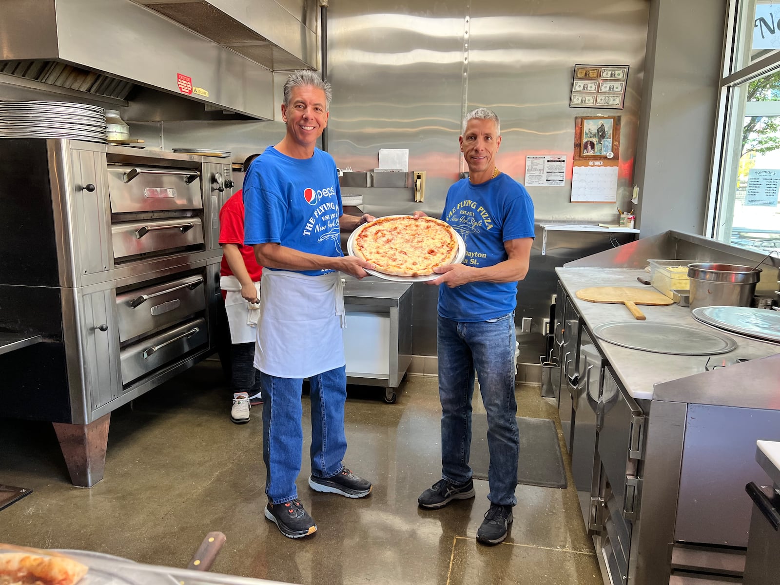 Tony and Frank Graci pose with pizza at Flying Pizza in downtown Dayton. ALEXIS LARSEN/CONTRIBUTOR