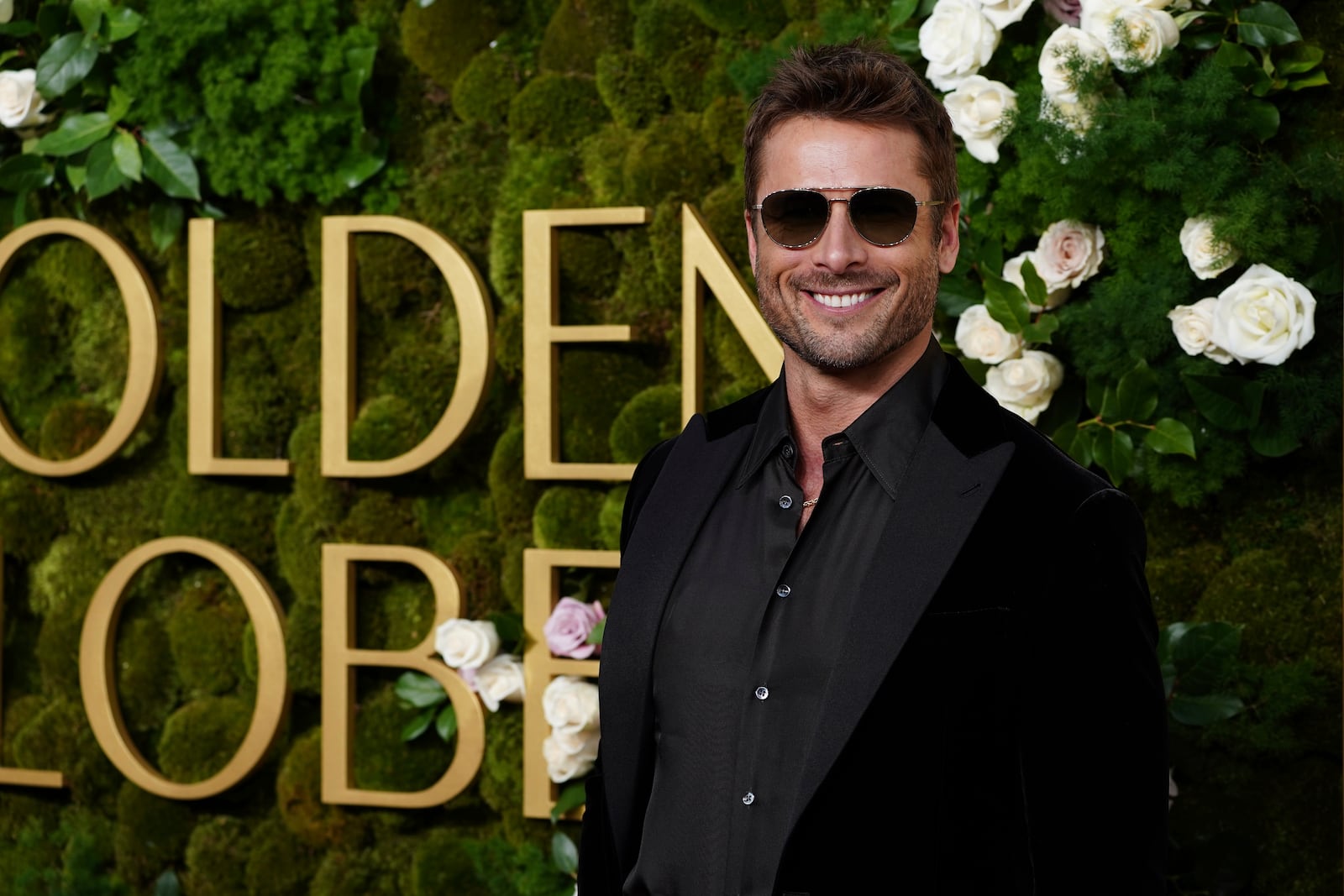 Glen Powell arrives at the 82nd Golden Globes on Sunday, Jan. 5, 2025, at the Beverly Hilton in Beverly Hills, Calif. (Photo by Jordan Strauss/Invision/AP)