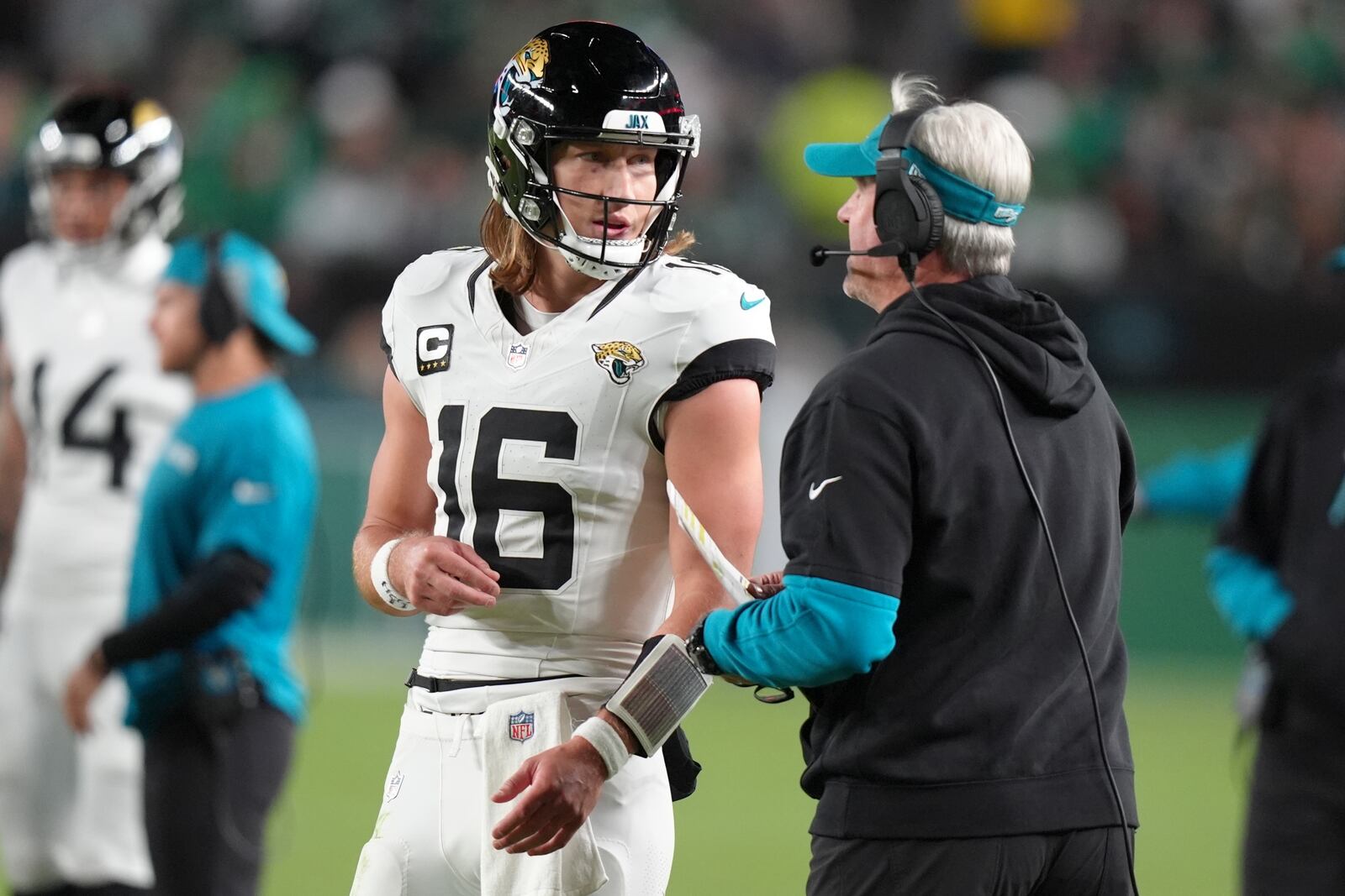 Jacksonville Jaguars quarterback Trevor Lawrence (16) talks to Jaguars head coach Doug Pederson during the second half of an NFL football game against the Philadelphia Eagles on Sunday, Nov. 3, 2024, in Philadelphia. (AP Photo/Chris Szagola)