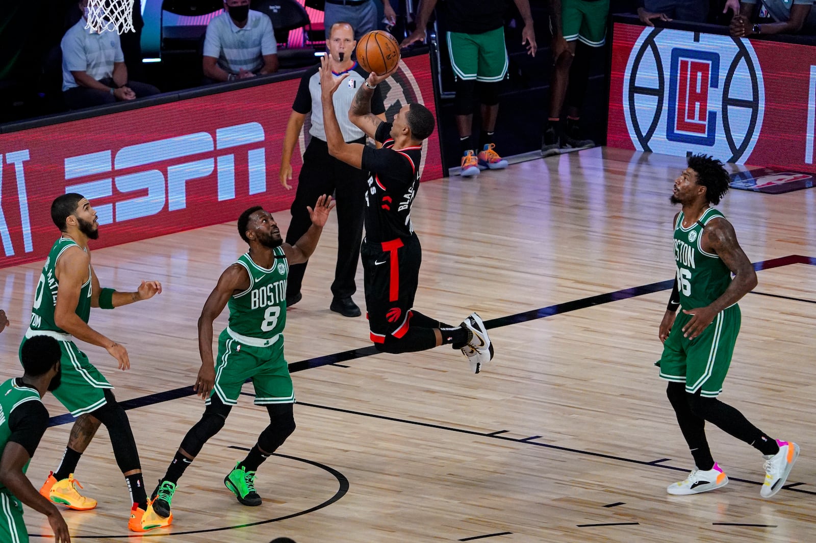 Toronto Raptors guard Norman Powell (24) shoots over Boston Celtics guard Kemba Walker (8) during the second half of an NBA conference semifinal playoff basketball game Wednesday, Sept. 9, 2020, in Lake Buena Vista, Fla. (AP Photo/Mark J. Terrill)