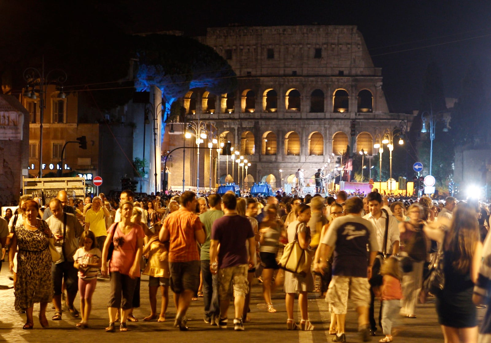 FILE - People gather at the Fori Imperiali avenue, with the Colosseum in the background, during an event celebrating the ban on private vehicles, in Rome, Saturday, Aug. 3, 2013. (AP Photo/Riccardo De Luca, File)