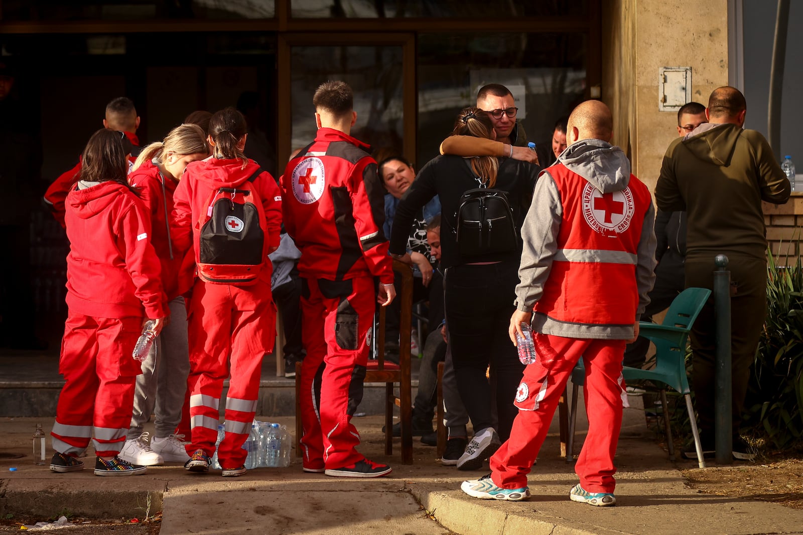 People hug outside a hospital in the town of Kocani, North Macedonia, Sunday, March 16, 2025, following a massive fire in the nightclub early Sunday. (AP Photo/Armin Durgut)